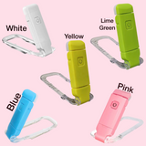 Five clip book lights  in different colors (White, Yellow, Lime Green, Blue, Pink) with clear carabiners clips, arranged on a light pink background with text labels.