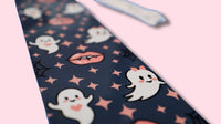 bookmark with ghost and vampire teeth pattern on a pink background