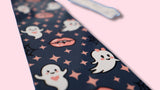 bookmark with ghost and vampire teeth pattern on a pink background