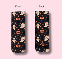 Two views of a bookmark with ghost and lip pattern on a pink background