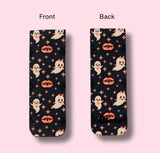 Two views of a bookmark with ghost and lip pattern on a pink background