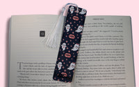 Book with a decorative bookmark featuring ghost designs on a pink background
