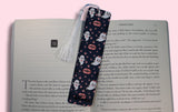 Book with a decorative bookmark featuring ghost designs on a pink background