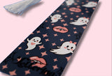Navy bookmark with ghost and vampire lips pattern on a pink background
