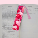 Heart-shaped pink and red bookmark on an open book