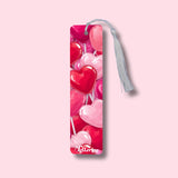Bookmark with heart-shaped lollipops design on a pink background