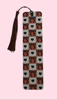 Aluminum bookmark with a checker pattern on a pink background