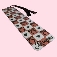 Decorative bookmark with hearts and bows pattern on a pink background