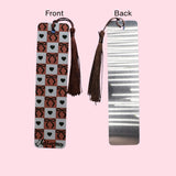 Bookmark with tassels on a pink background, showing front and back designs.