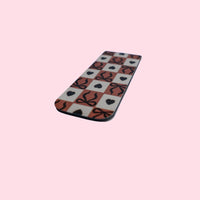 Checkered bookmark with hearts and bows on a pink background