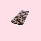Checkered bookmark with hearts and bows on a pink background