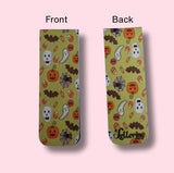 Two magnetic bookmarks with Halloween-themed designs on a pink background, showing the front side and back side designs.