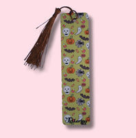 Decorative bookmark with Halloween-themed design on a pink background