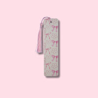 Aluminum bookmark with pink bows on a pink background