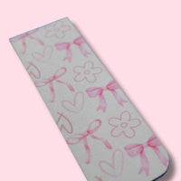 Magnetic bookmark with pink floral, hearts and bow patterns on a light pink background