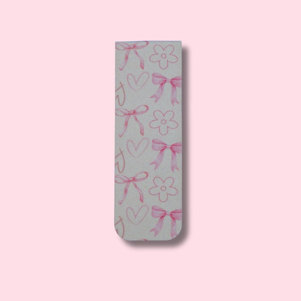 Bookmark with pink bows, hearts, and flowers on a pink background