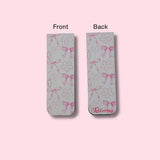 Two bookmarks showing the front and back side of the bookmark with bows, hearts, and flowers pattern on a pink background