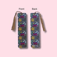 Two views of an aluminum bookmark with tassel on a pink background