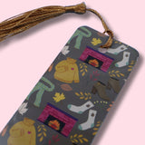 Colorful bookmark with tassel on a pink background