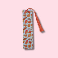 Bookmark with leaves pattern and tassel on a pink background