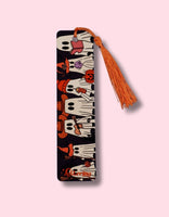Decorative ghosts bookmark with tassel on a pink background