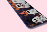 Aluminum bookmark with ghost design on a pink background