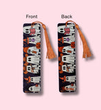 Bookmark with tassels, one showing front and the other back, on a pink background.