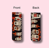 Two views of a magnetic bookmark with a ghost pattern on a pink background
