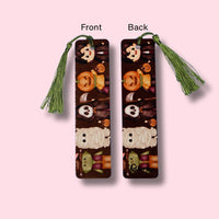 Two bookmarks with tassels, one showing front view and the other the back, on a pink background.