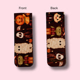 Two views of a magnetic bookmark with Halloween-themed design on a pink background