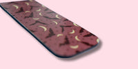 Purple magnetic bookmark with bats and crescent pattern on a pink background