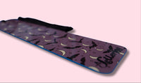 Purple bookmark with black bat design and A Lettering Story logo on a pink background