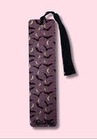 Purple bookmark featuring Bats and crescent moons with a black tassel on a pink background
