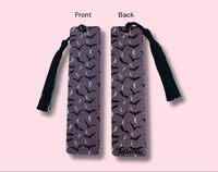 purple bookmark with a front and back view on a pink background