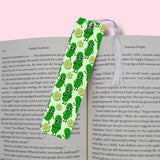 Green pickles patterned bookmark on a book with a pink background