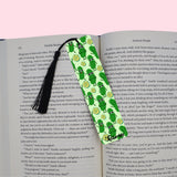 Green pickles-themed bookmark on an open book