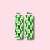 Two magnetic bookmarks with a green pickle pattern on a pink background