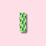 Magnetic bookmark with green pickle design on a pink background