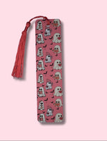 Pink bookmark with tassel and ghost pattern on a pink background