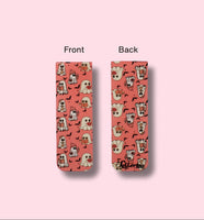 front and back side of bookmark with ghost pattern, one showing front and the other back, on a pink background.