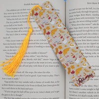 Fall-themed bookmark with tassel on an open book