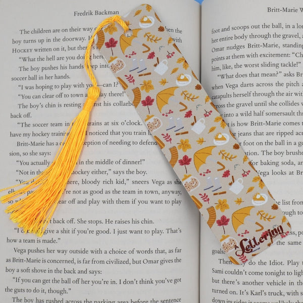 Fall-themed bookmark with tassel on an open book