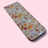 Magnetic bookmark with autumn-themed design on a pink background