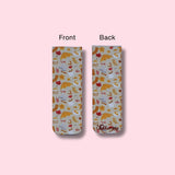 Two views of a magnetic bookmark with a colorful autumn design on a pink background