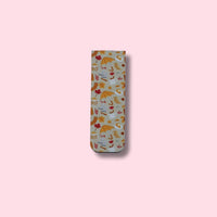 Fall patterned magnetic bookmark on a pink background