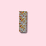 Fall patterned magnetic bookmark on a pink background