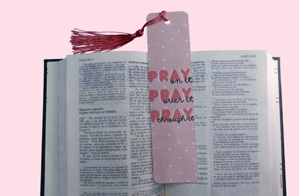 Pink Aluminum Double Sided Bookmark with quote Pray On it, Pray Over it, Pray through it on top of a book