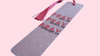 Pink aluminum Bookmark with quote "Pray on it, Pray over it, Pray through it" and salmon color tassel on a pink background