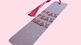 Pink aluminum Bookmark with quote "Pray on it, Pray over it, Pray through it" and salmon color tassel on a pink background