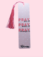 Pink Bookmark with quote "Pray on it, Pray over it, Pray through it" and salmon-color tassel on a pink background